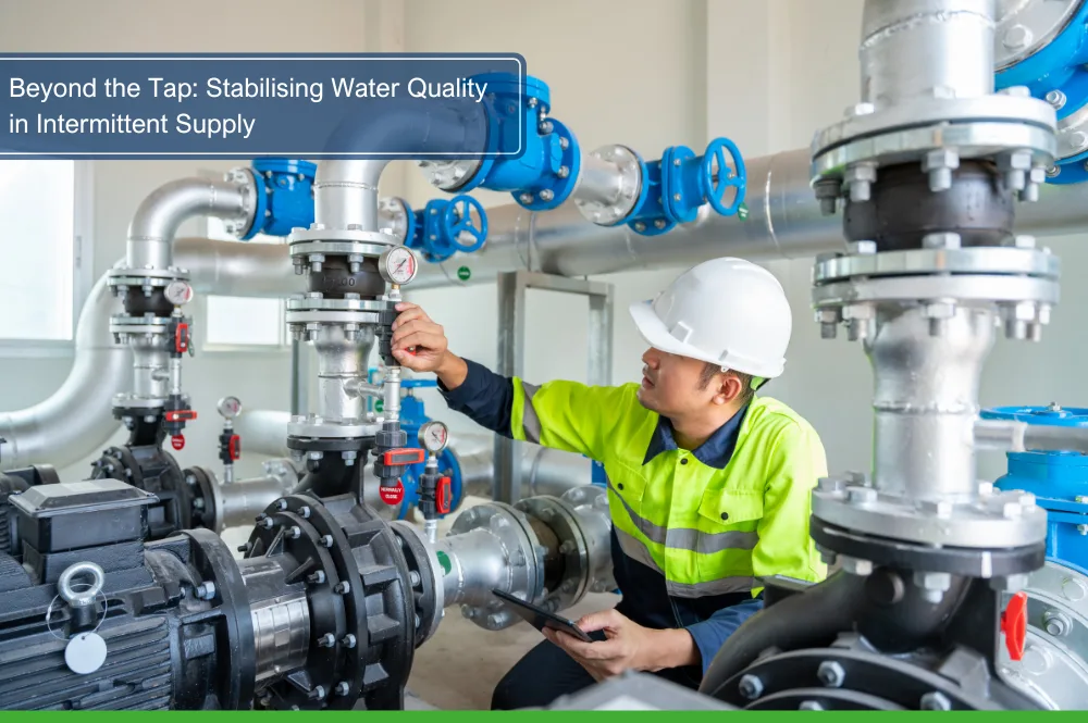 Industrial technician inspecting industrial water pipes and pressure gauges during intermittent supply stabilisation